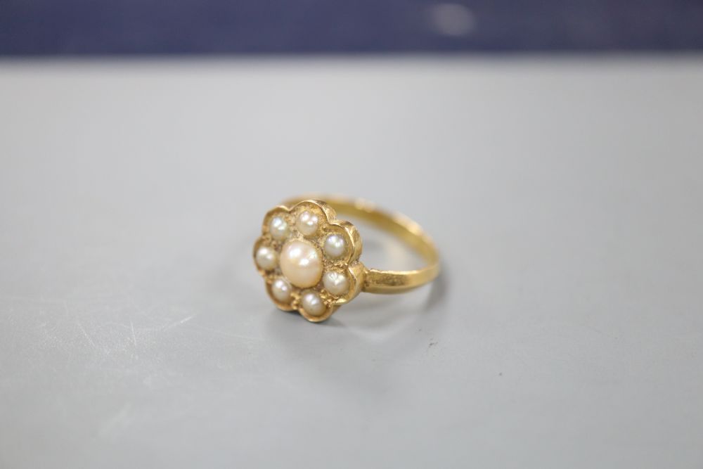 A yellow metal and seven stone split pearl cluster ring, size P/Q, gross 3.8 gram.